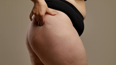 Woman Checking Thigh and Skin Texture in Underwearの写真素材