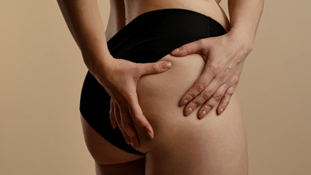 Woman Checking Thigh and Skin Texture in Underwearの写真素材