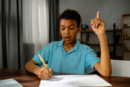 Surprised Young African American Child Boy Expressing Excitement in Classroomの写真素材
