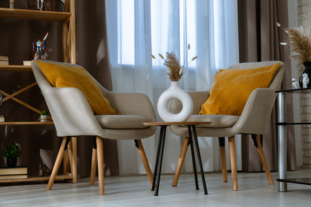 Cozy Modern Interior with Two Beige Armchairs and Wooden Tableの写真素材