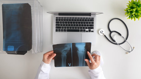 Doctor Reviewing X Ray Image at Modern Medical Office Desk