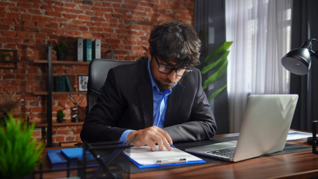 Focused Professional Writing Notes in Modern Officeの写真素材