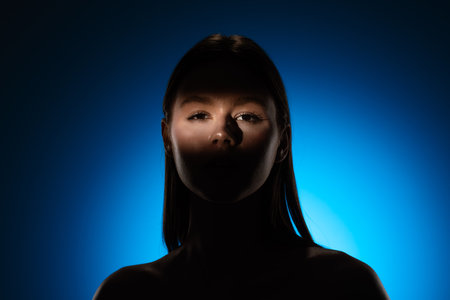Captivating Portrait with Dramatic Shadow Play and Light Beamの写真素材
