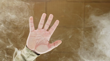 Raised Hand with Rising Smoke Below the Glass Table