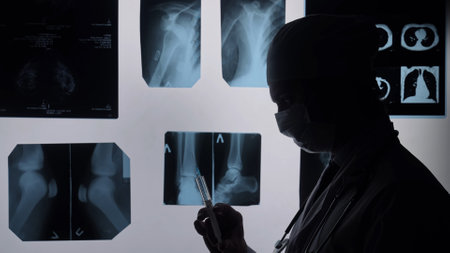 Doctor Analyzing Medical X Ray Images in Hospital Roomの写真素材