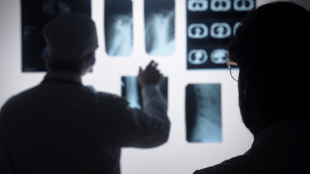 Doctors Analyzing and Discussing X Ray Medical Imageryの写真素材