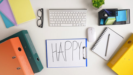 Organized Desk Setup with Stationery and Happy Signの写真素材