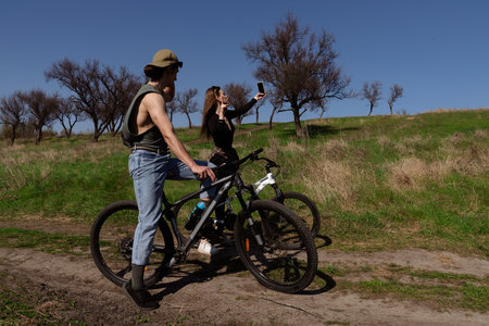 Cyclists Taking a Scenic Selfie on a Sunny Day Outdoorsの写真素材