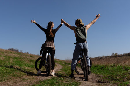 Joyful Bike Ride through Open Fields on a Sunny Dayの写真素材