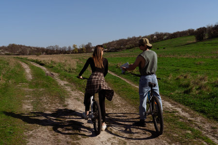 Young Couple Enjoying a Scenic Country Bike Ride Togetherの写真素材
