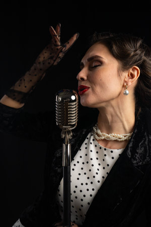 Elegant Woman Singing with Vintage Microphone and Pearl Jewelry