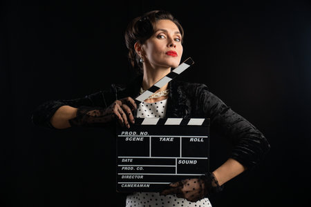 Classic Film Actress Holding Retro Movie Clapperboard in Styleの写真素材