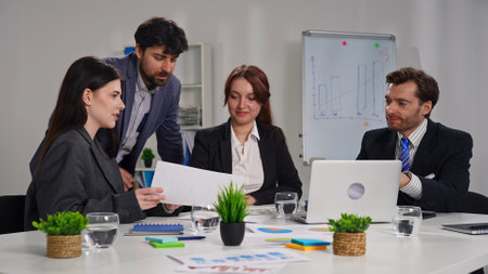 Business Meeting with Four People in Office Setting