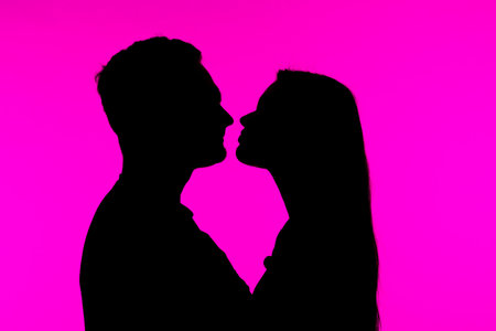 Silhouette of Couple in Artistic Pink Background Portraitの写真素材