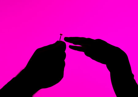 Silhouette of Hands With Nail on Pink Backgroundの写真素材