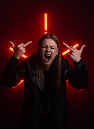 Expression of Anger Captured in Neon Red Glowing Lightsの写真素材