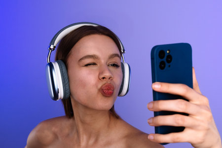 Young Woman with Headphones Taking a Selfie with Smartphone