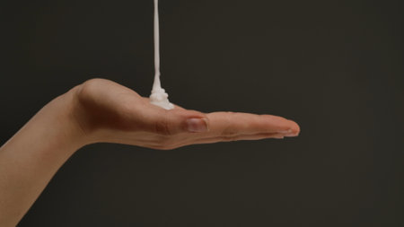 Close-up of a Hand with Lotion Being Poured onto Palm