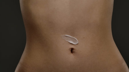 Moisturizing Cream Applied to Skin on a Persons Midsection
