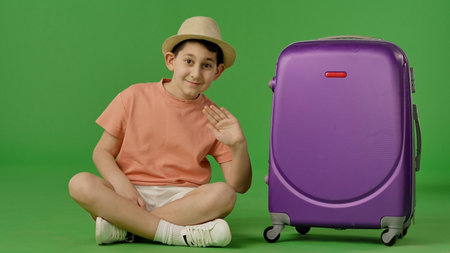 Cheerful Traveler with Large Purple Suitcaseの写真素材
