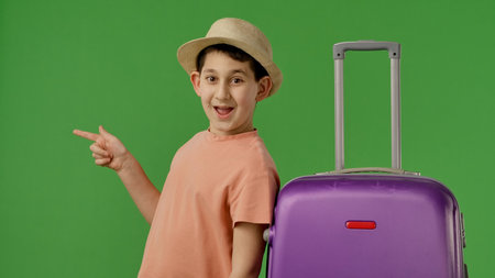 Young Traveler with Purple Suitcase on Green Backgroundの写真素材