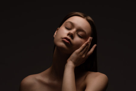 Tranquil Portrait of a Woman with Eyes Closed and Gentle Expressionの写真素材