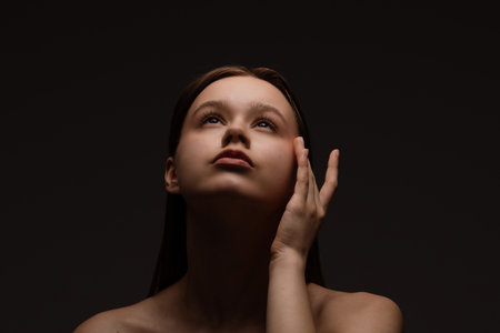 Portrait of Woman with Soft Lighting and Contemplative Expressionの写真素材