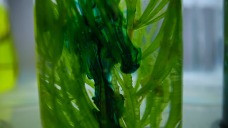 Plant roots suspended in clear liquid inside laboratory test tube