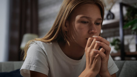 Contemplative Young Woman Sitting in Home Interior