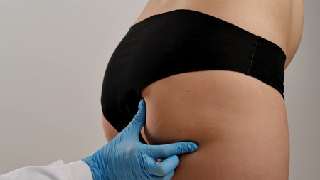 Doctor Performing Body Examination Wearing Blue Glovesの写真素材