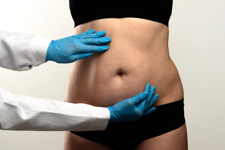 Healthcare Professional Examining Patients Abdominal Areaの写真素材