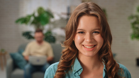 Young Woman Smiling in a Cozy Room with Blurred Background