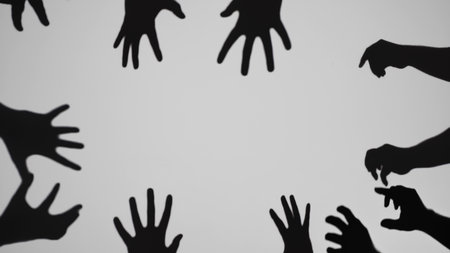 Creative Shadow Art with Multiple Hands on Gray Backgroundの写真素材