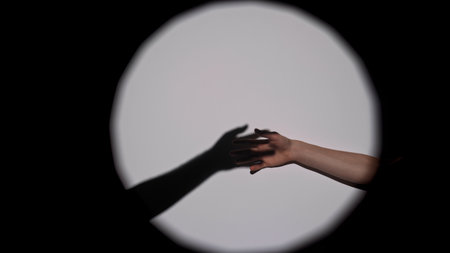 Shadow and Hand Reach in Artistic Circle Compositionの写真素材