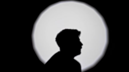 Silhouette of a Person Against a Bright Circle Background