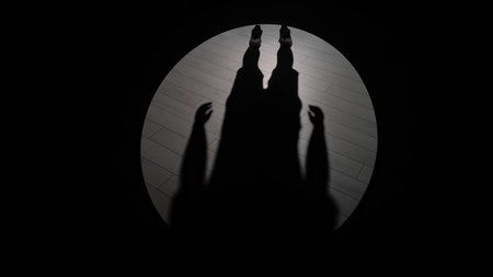 Mysterious Shadow of a Person on Wooden Floor Illuminated by Spotlightの写真素材