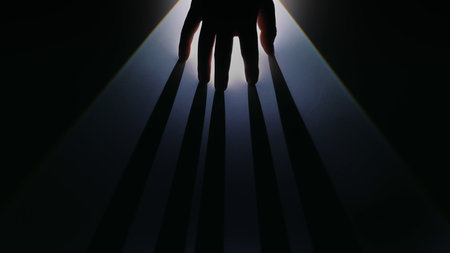 Mysterious Hand Casting Long Shadows in Dark Light