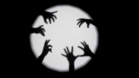 Creative Shadow Art with Hands Against Lightの写真素材