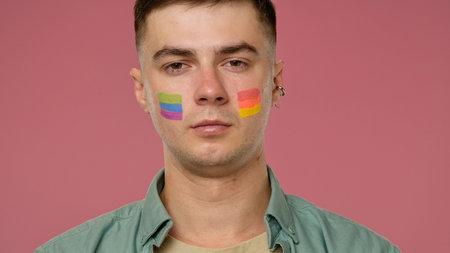 Young Person with Rainbow Face Paint Celebrating Prideの写真素材