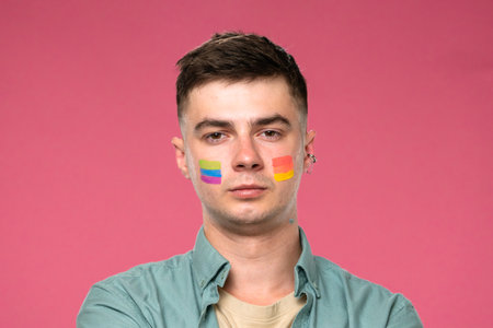 Man with Colorful Face Paint on Pink Background Celebrating Diversityの写真素材