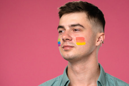 Colorful Pride Face Paint Design with Pink Backgroundの写真素材