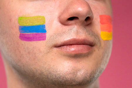 Face with colorful paint stripes symbolizing pride and diversityの写真素材