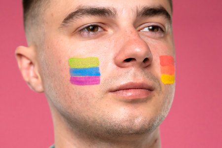 Portrait of a Man with Colorful Face Paint in Support of Prideの写真素材