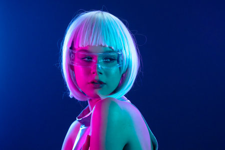 Futuristic woman in neon light with holographic smart glassesの写真素材
