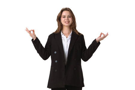 Confident Young Professional Demonstrating Relaxation Techniques isolated on white backgroundの写真素材