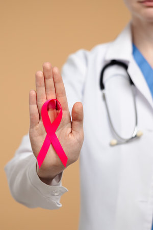 Medical Professional Holding a Symbolic Pink Awareness Ribbonの写真素材