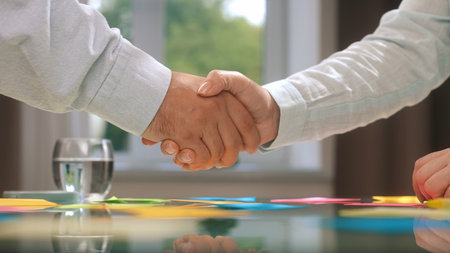 Business Agreement Handshake Over a Modern Conference Tableの写真素材