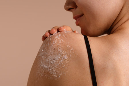 Woman Gently Exfoliating Shoulder with Body Scrub, Close-up Viewの写真素材