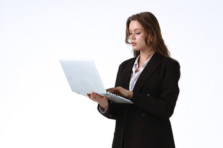 Young Professional Woman Working on Laptop in Office Environment isolated on white backgroundの写真素材