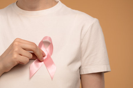 Woman Holding Pink Ribbon for Breast Cancer Awarenessの写真素材
